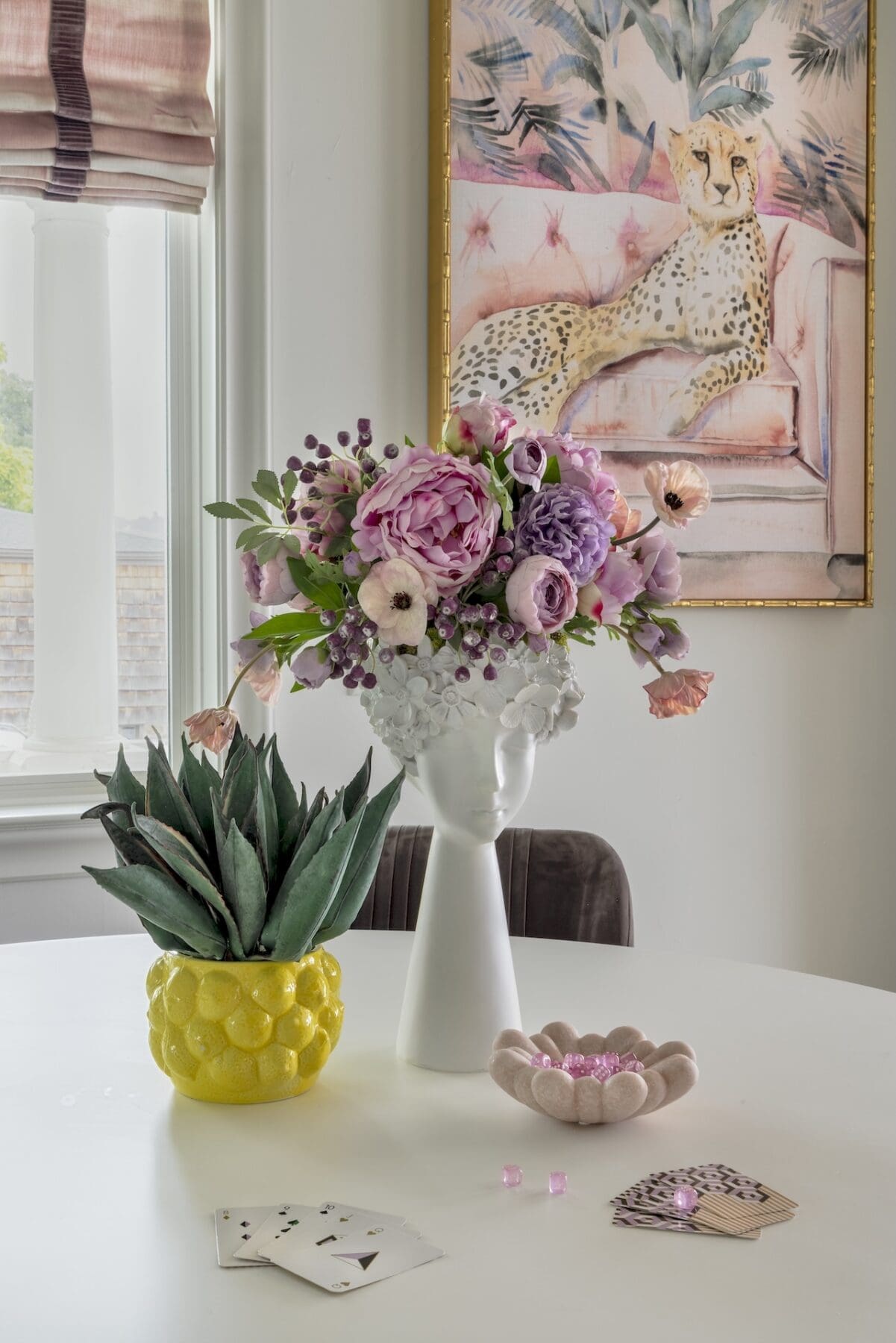 Custom floral design for the home featuring peonies in a yellow ceramic vessel on a white kitchen island at River House by Curate Florals